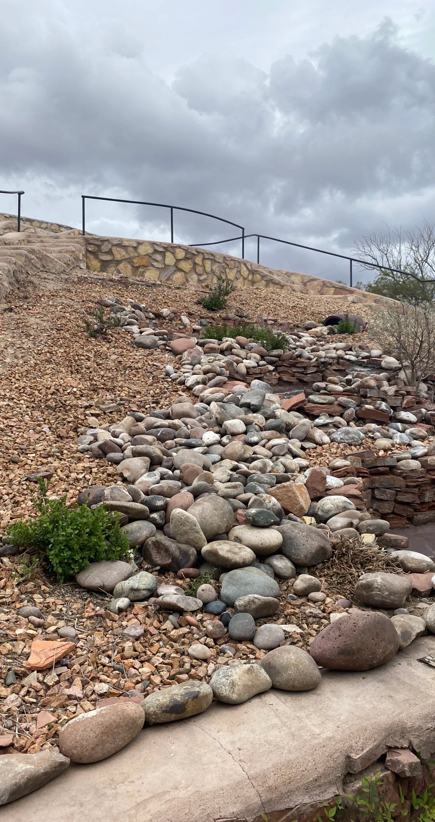 Dry-stack stone wall and slope erosion control by Brainard's Greenscapes in Las Cruces, NM